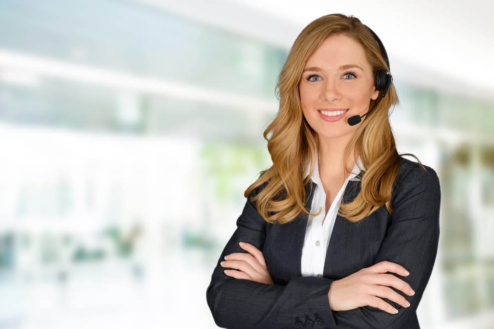 A smiling customer service representative wearing a headset