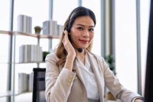 agent with headset assigned to handle the customer support outsourcing of a business