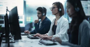 three technical support outsourcing reps working taking client calls