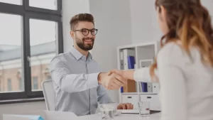 medical records retrieval representative shaking the hand of a business owner