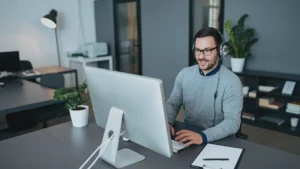 e-commerce bpo expert working on a desktop computer with a headset on