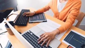 A person working on multiple computers