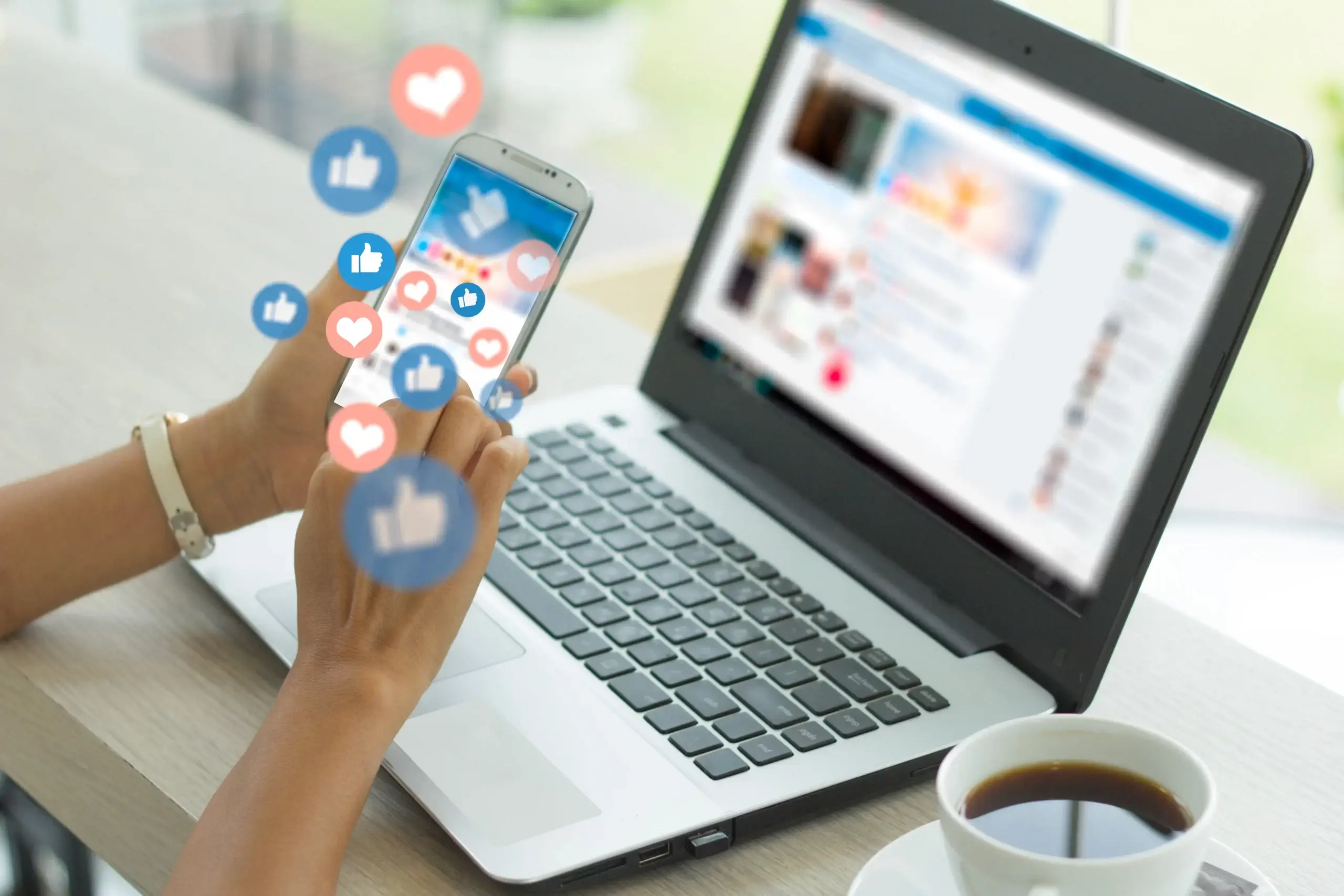 person unlocking social media marketing outsourcing secrets on laptop and phone