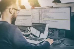 A person working on multiple computers