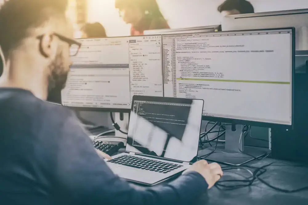 A person working on multiple computers