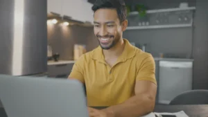 a man who is outsourcing his article writing on his laptop