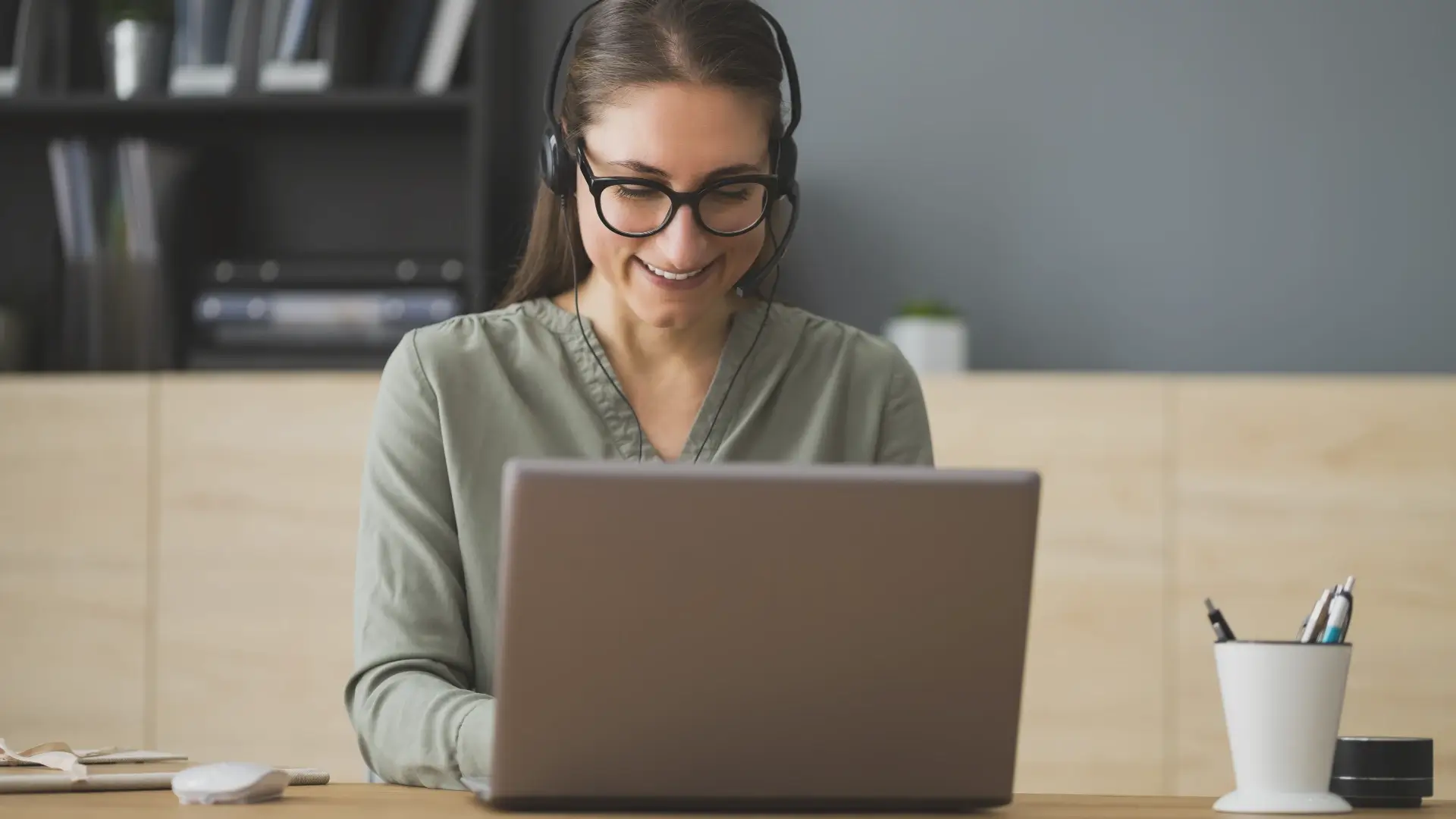 a happy business owner speaking with their overseas virtual assistant on a laptop video call delegating tasks to them