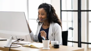 a startup business owner speaking to their outsourced virtual assistant via a laptop video call