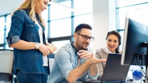 a group of company owners speaking to outsourced virtual assistants via a laptop video call