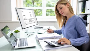 a stressed business owner working on her own accounting tasks