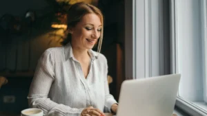 a lawyer delegating tasks to her legal virtual assistant via a laptop in a coffee shop