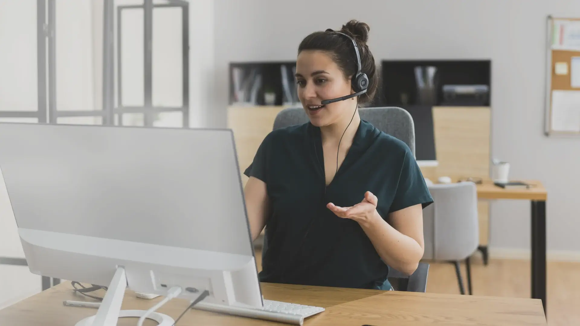 Virtual assistant wearing a headset working at a desk with text overlay about Amazon Virtual Assistant services.