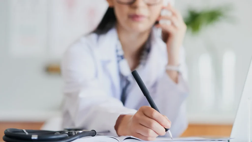 A person who is in a call while taking down notes