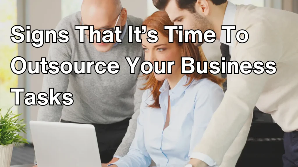 business professionals collaborating in front of a laptop