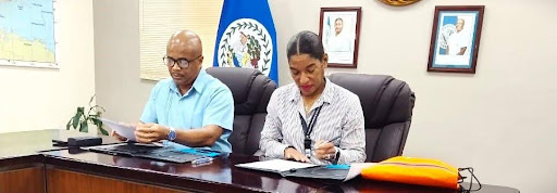 Representatives from Peak Outsourcing International BLZ LTD. and Belize City Council signing a memorandum of understanding