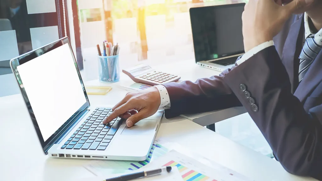 Business professional working on a laptop, representing streamlined Shopify product data entry.