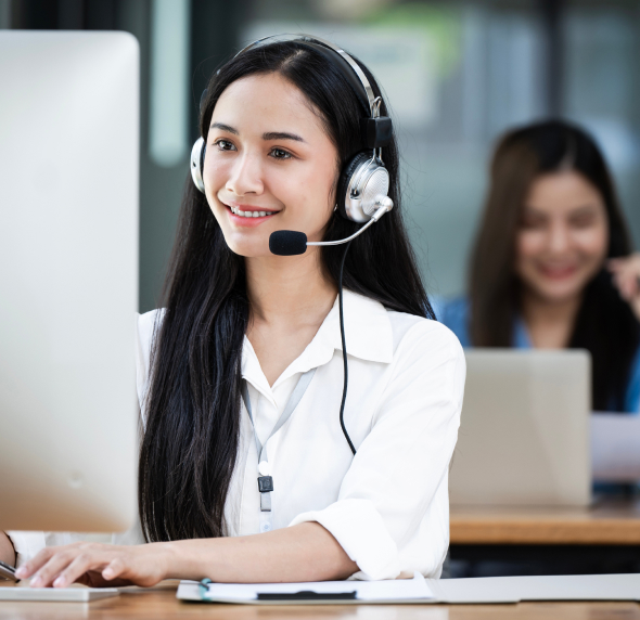An e-commerce representative happily working on her computer