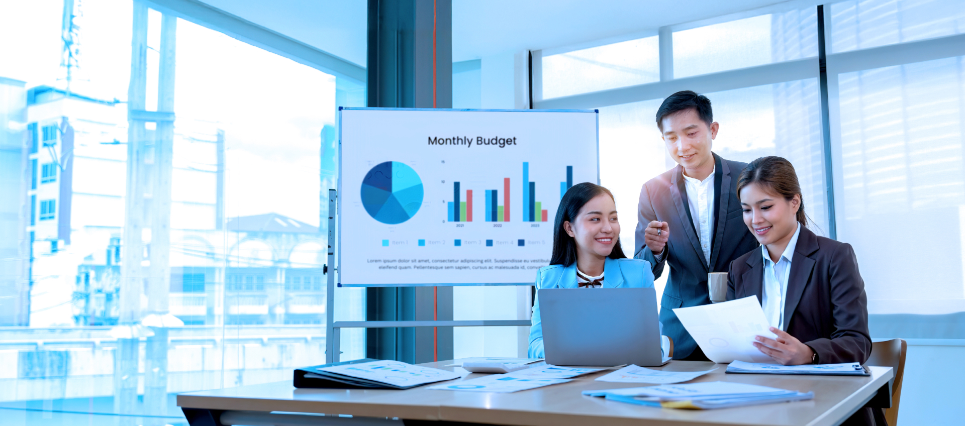 Team discussing financial data with charts displayed on a screen