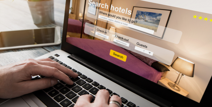Person using a laptop to search for hotels online