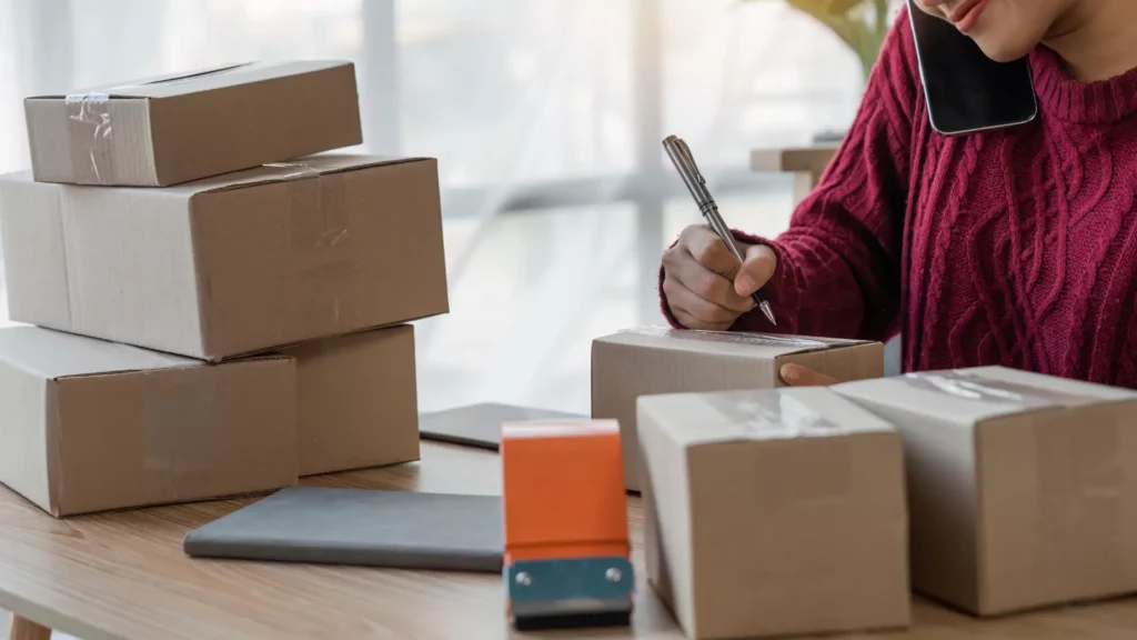 Person preparing packages, highlighting efficient e-commerce customer service with outsourced support.