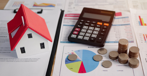 An image of a house, calculator, coins, and a file with a pie graph