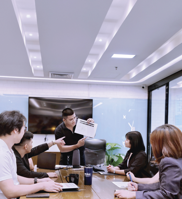 Team members collaborating in a meeting, emphasizing growth and teamwork