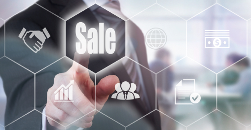 A person touching the screen which shows various logo about sales and business