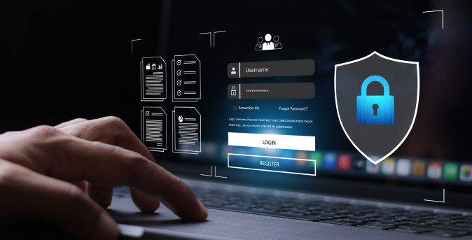 Close-up of a hand on a laptop with a login screen and security shield icon