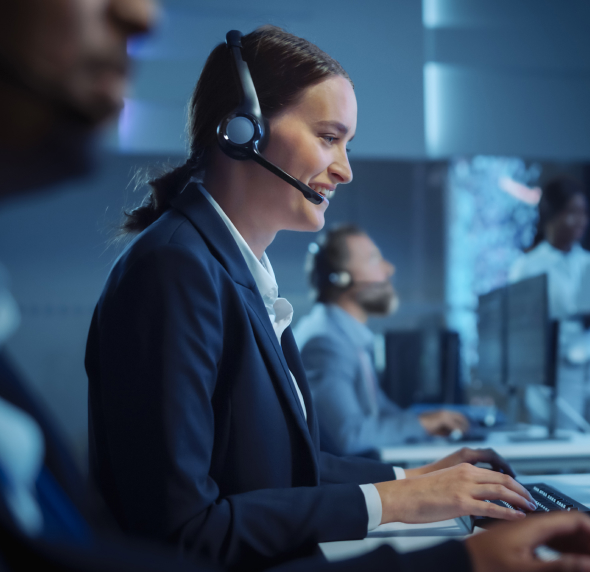 Call center IT outsourcing expert wearing a headset, working on a computer