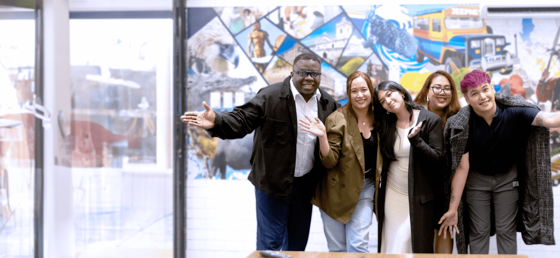 A diverse team celebrating success, symbolizing collaboration in cross-border shipping and the benefits of outsourcing logistics.