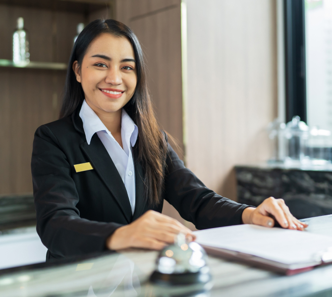 a receptionist smiling to show hospitality and greetings