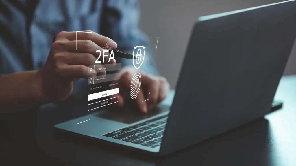 Person using two-factor authentication (2FA) on a laptop with fingerprint scanning