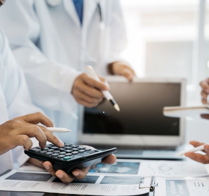 Image of Medical Professionals holding a calculator