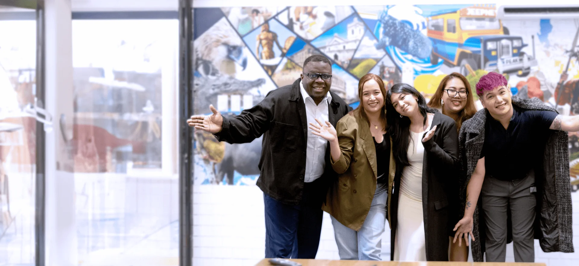 A diverse team celebrating success, symbolizing collaboration in cross-border shipping and the benefits of outsourcing logistics.