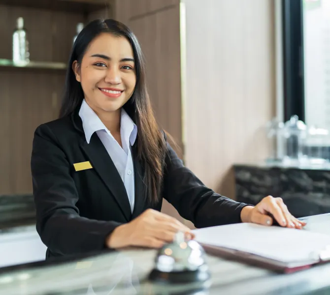 a receptionist smiling to show hospitality and greetings